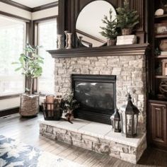 a living room filled with furniture and a fire place in front of a large window