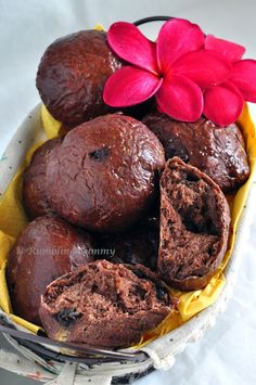 chocolate muffins in a basket with a red flower