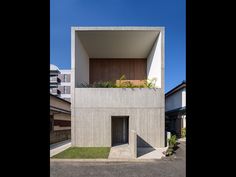 the house is made out of concrete and has plants growing on it