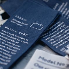 some blue business cards are laying on top of each other with the words wash and care printed on them