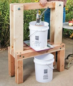 a man standing next to a table with buckets on it