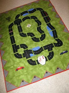 a quilted play mat with cars on it