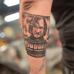 a person with a tattoo on their leg that has a picture of a man's face