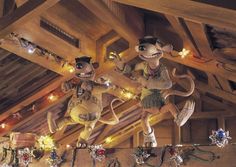 two mice are standing on top of the shelf in front of some lights and decorations