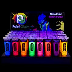 neon paint glows on display in front of a black background with an ad for the company