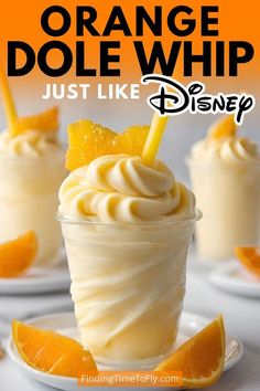 orange dole whip in a glass with an orange slice on top and the words just like disney