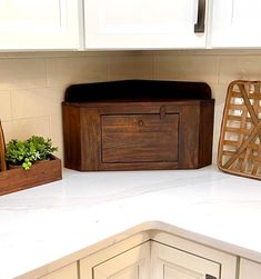 kitchen counter with white cabinets and wooden utensils