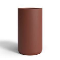 a brown vase sitting on top of a white surface