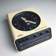 an old fashioned clock sitting on top of a table