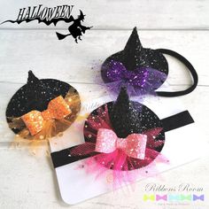 two halloween hair bows with sequins on them