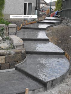 some steps that are made out of concrete and have water running down the side of them