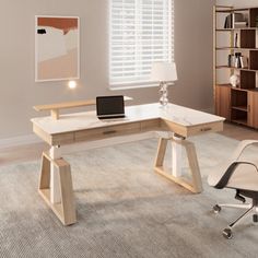 a desk with a laptop on it in a room