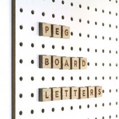 some type of word spelled with wooden letters on a peg board that says peg, board, and letters