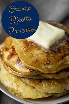 stack of pancakes with butter on top and blue circle over the top that says orange ricotta pancake