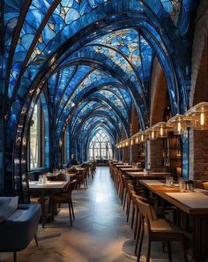 the inside of a restaurant with many tables and chairs, blue stained glass ceilinging