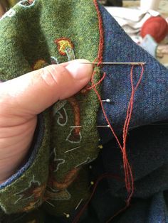 someone is stitching something on top of some fabric