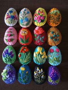 an assortment of decorated eggs sitting on top of a table