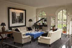 a living room filled with furniture and a piano