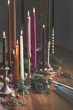 a table topped with lots of candles next to scissors and other items on top of it