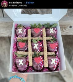 chocolate covered strawberries in a white box with pink flowers and hearts decorated on them