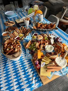 a table topped with lots of food on top of a blue and white checkered table cloth