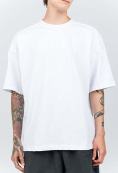 One size. fits xs-xl    color: white    oversized boxy fit    classic white tee    80% cotton 20% polyester    dry clean only    by the nkc store    chest: 122cm / 48in    length: 74cm / 29in    model is 185cm / 6'1" wearing size o/s White Classic Boxy Fit T-shirt, White Boxy Classic T-shirt, White Boxy Fit Cotton T-shirt, White Boxy Fit T-shirt With Crew Neck, White Boxy Fit Urban T-shirt, White Boxy Fit Drop Shoulder T-shirt, White Relaxed Fit Drop Shoulder T-shirt, Oversized White Drop Shoulder Top, White Oversized Drop Shoulder Top