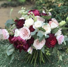 a bouquet of flowers sitting on the ground