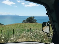 the view from inside a vehicle looking out at an island