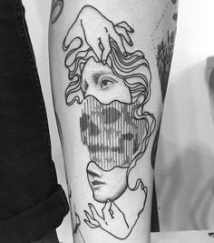 a woman's leg with tattoos on it and an image of her face in the middle