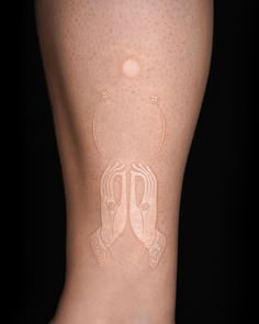 a woman's legs with white lines on them and an image of two people in the background