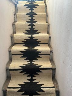 the stairs are decorated with black and white rugs, which is on top of each other