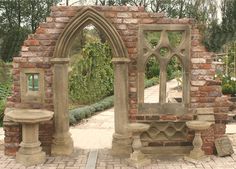 an arch in the middle of a brick garden