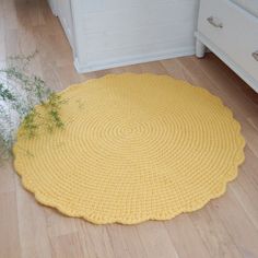 a yellow rug is on the floor next to a dresser