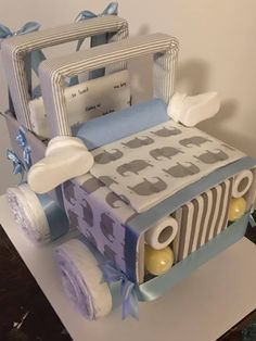 a cake made to look like a baby's bed with blue and white decorations