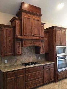 a kitchen with wooden cabinets and granite counter tops