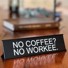 a sign that says no coffee? no workee on a table with books in the background