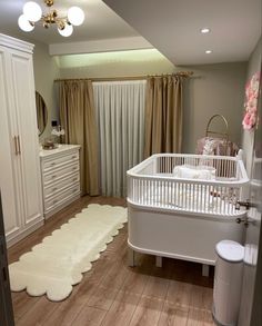 a baby's room with a crib, dresser and changing table in it