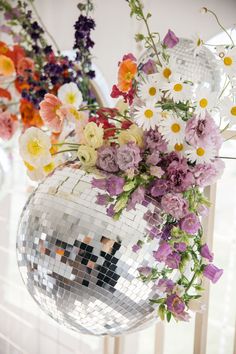 a mirror ball filled with lots of flowers