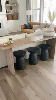 a living room filled with furniture and a wooden table