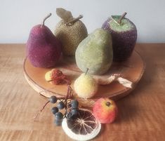 three different types of fruit on a wooden plate