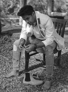 a man sitting on top of a wooden chair