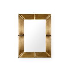 a mirror that is sitting on top of a wall next to a white wall with a black and gold frame