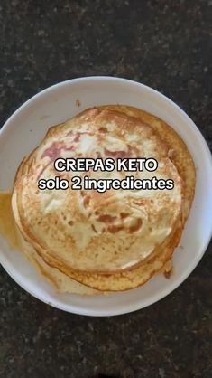 pancakes on a white plate with the words crepas keto solo 2 ingredients