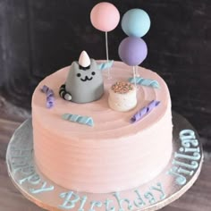 a birthday cake decorated with balloons and cats