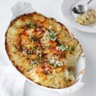 a casserole dish with potatoes and herbs