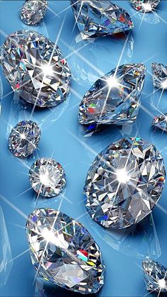 many different types of diamonds on a blue surface with white lines in the middle and light shining through them