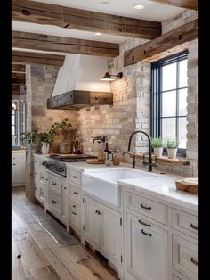 a kitchen with white cabinets and wooden beams on the ceiling is decorated in rustic style