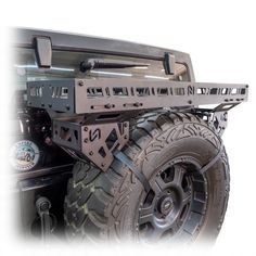 the front end of a truck with an atv rack on it's back tire