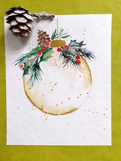 a watercolor painting of a christmas ornament with pine cones and berries on it