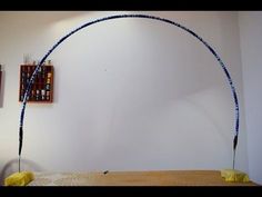 a room with a bed and two pictures on the wall, one has a long blue string attached to it